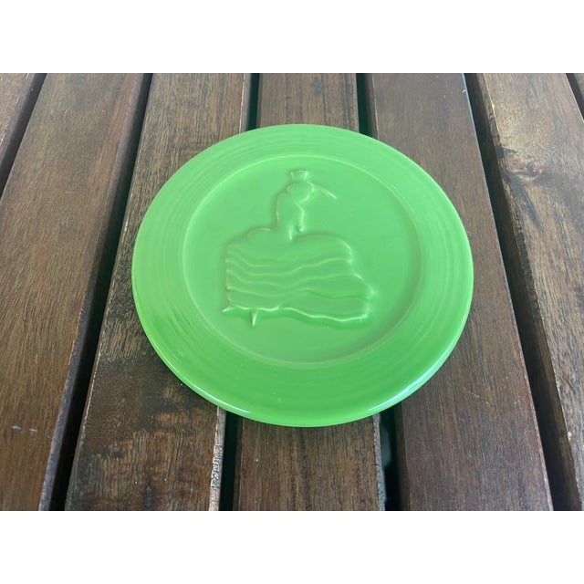 This is a retired Fiesta 6-inch round trivet in the "Shamrock" green color, featuring the "Dancing Lady" design. It was...