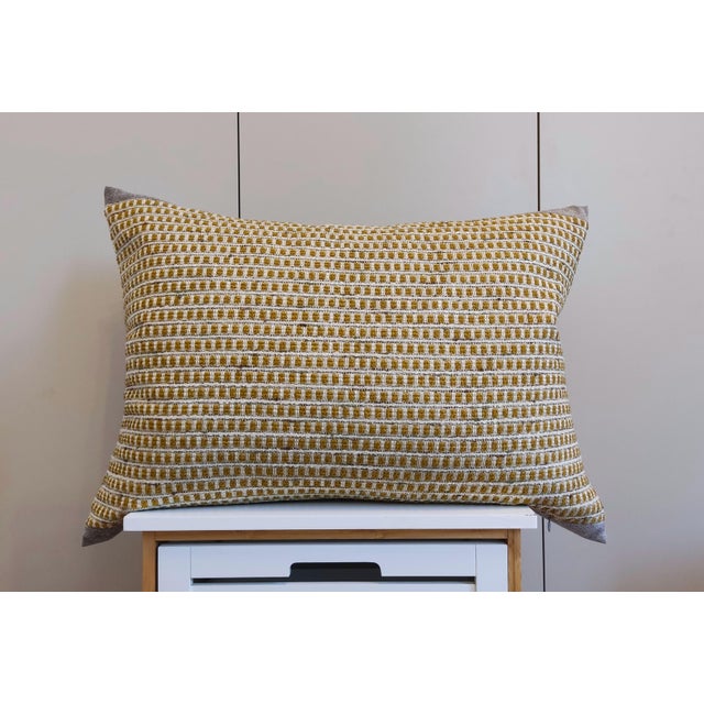 The decorative pillows feature a dual-sided design (structured Ochre waffle on the front and ultra-soft Platinum Grey...