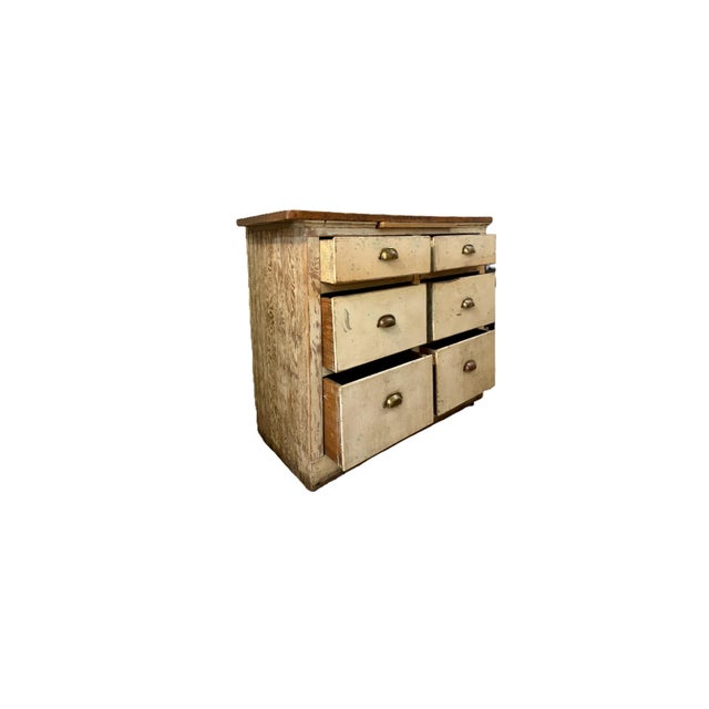 This antique primitive cabinet exudes rustic charm with a weathered paint finish and original hardware. An early 20th...