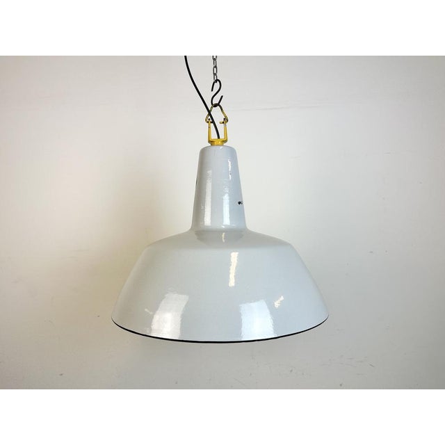 Industrial light grey enamel factory pendant light made by philips in netherlands during the 1960s. White enamel inside...