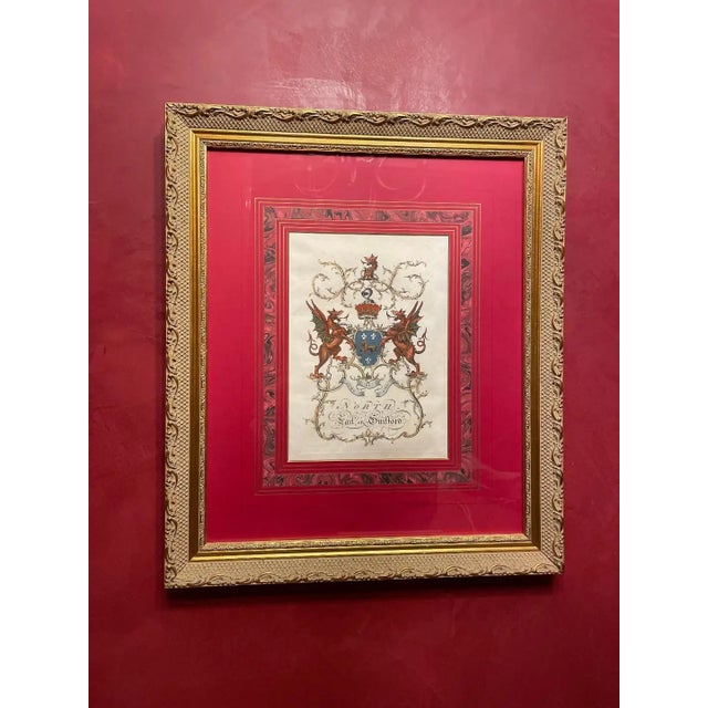 Heraldry crests emblazoned with red, blue, and pale colors. Hand-colored in watercolor. Striking style and impressive...