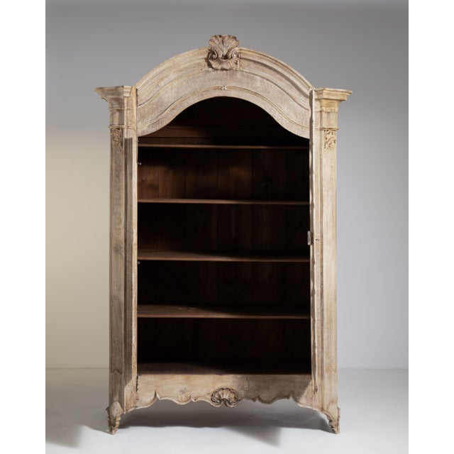 A distinguished example of Louis XV influence carried into the early nineteenth century, this French oak wardrobe reflects...
