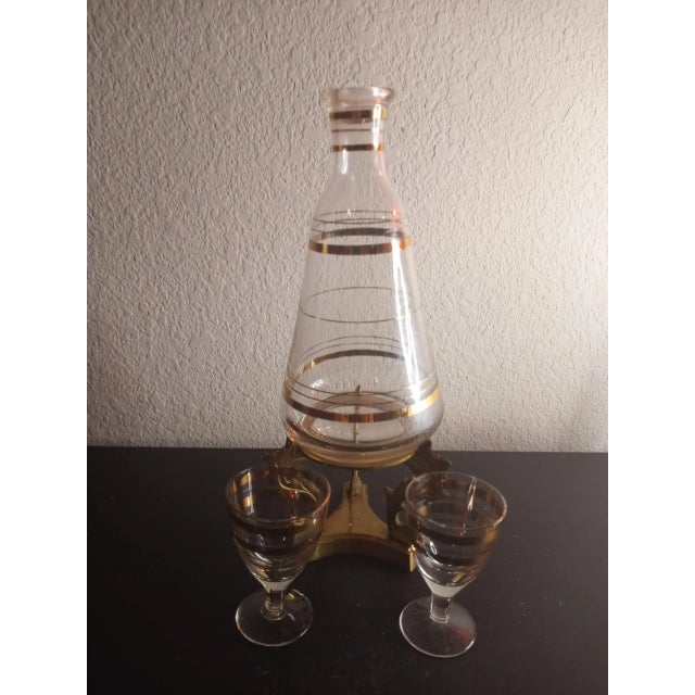 These are EXQUISITE 1950 Made in France Art Deco 8" Carafe on Brass Stand. Carafe comes with 2 shot glasses Procured at...
