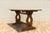 Beautiful antique American trestle dining table dating to the 1930s, featuring a solid oak top and a richly toned cherry...