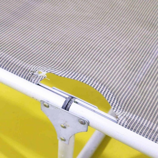 Pair of folding sun loungers in aluminum and perforated fabric.
