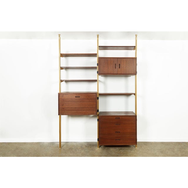 This vintage mid century modern Omni wall unit shelving system designed by George Nelson is circa 1960. This ingenious...