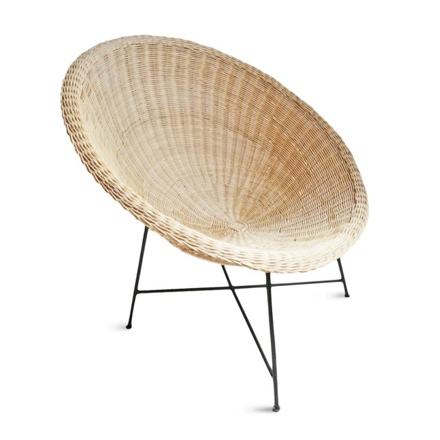 Midcentury modern coastal style hand crafted natural woven rattan round cup chair with simple black iron legs. Seat height...