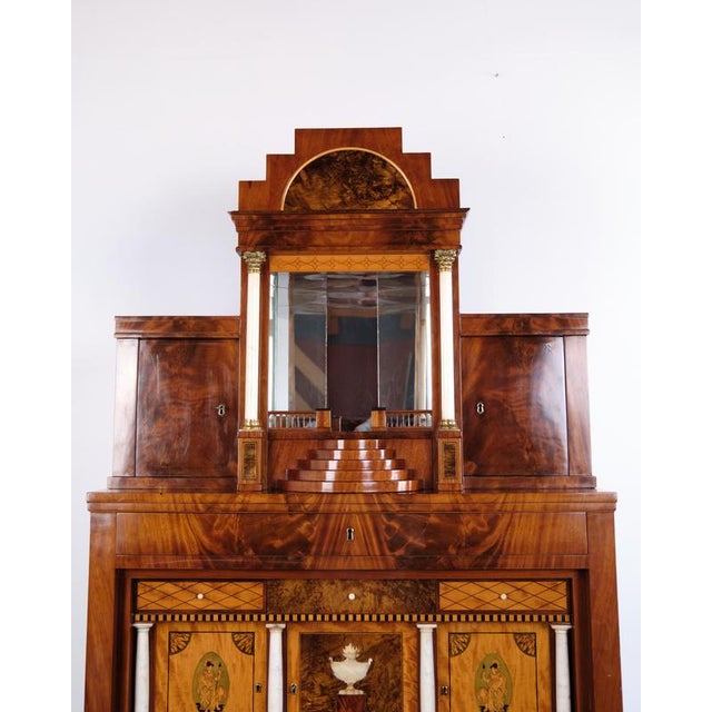 Empire secretary desk made in hand-polished mahogany with marquetry from the 1840s. The piece features a stepped upper...