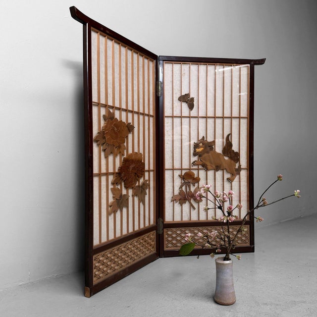 Refined two-panel screen from Japan, constructed as a small shōji-style screen with a lacquered wooden frame and washi...