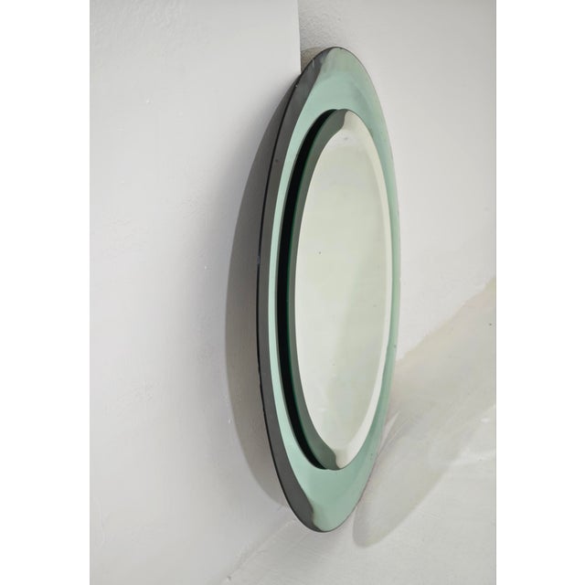 Round wall mirror attributed to Crista Art, made in Italy in the 1960s/70s. The key features of the multi-level design...