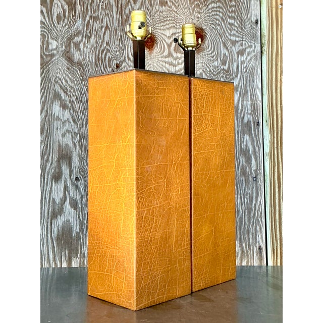 Elevate your space with this exquisite pair of vintage boho wrapped leather lamps. Their unique rectangular design,...