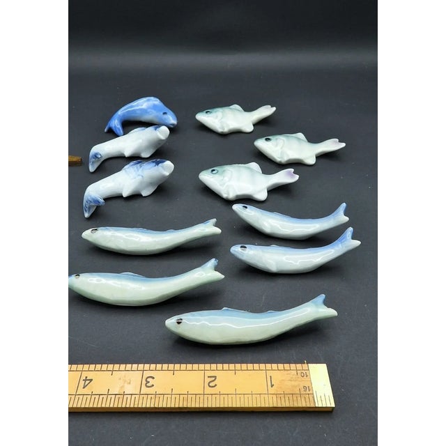 This marvelous set of 11 vintage 1960s-1970s Japanese chopstick rests are created in gorgeous blue and white porcelain, in...