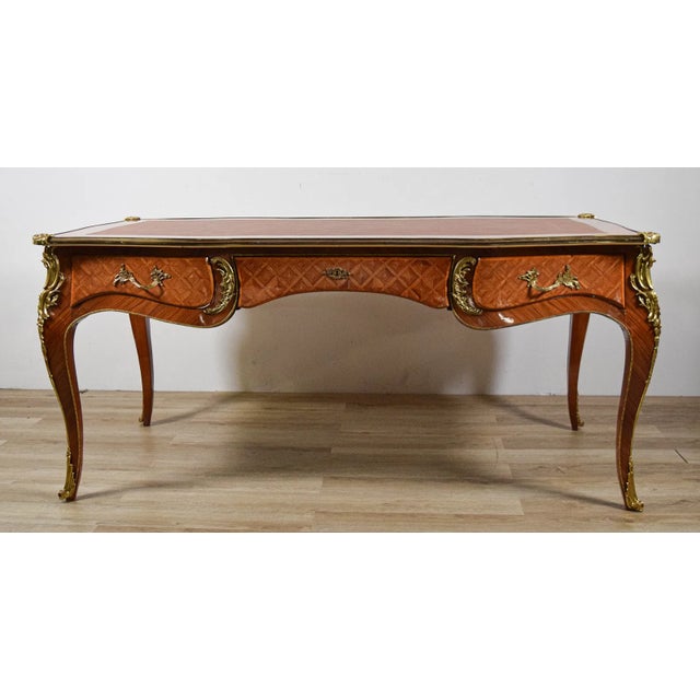 Exquisite French Louis XVI style executive desk featuring a supple tooled leather top and intricate marquetry veneer...