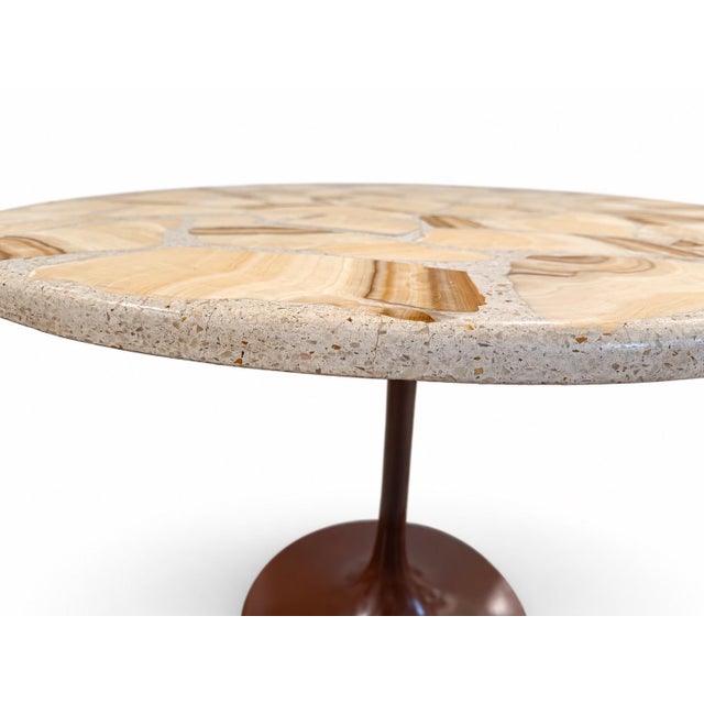 Striking vintage pedestal table with a steel tulip-style base and a heavy stone mosaic top in cream, tan, and caramel...