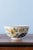 This 18th-century Dutch Delft bowl displays an elegant polychrome decoration of a willow tree rising above pierced rocks,...
