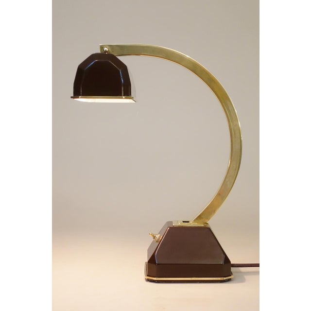 A rare and visually stunning Streamline Moderne sculptural solid Brass & Brown enameled metal articulating table lamp...