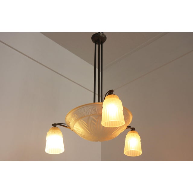 This elegant French Art Deco chandelier, dating to circa 1925 and attributed to the renowned glassmakers Muller Frères of...