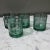 The product is a set of four vintage Anchor Hocking low ball green glasses, made in the United States These mid-century...