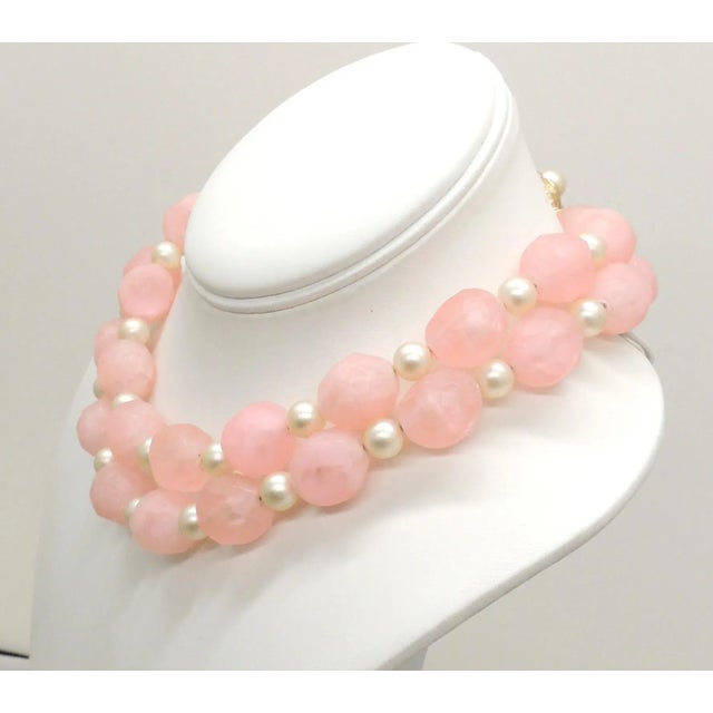 This is part of Chairish’s Costume Jewelry assortment. 1960s 2 strand goldtone pink faceted beads with smaller faux-pearl...