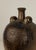 19th Century French Provincial stoneware jug with central spout, twin size handles and drip manganese glaze.