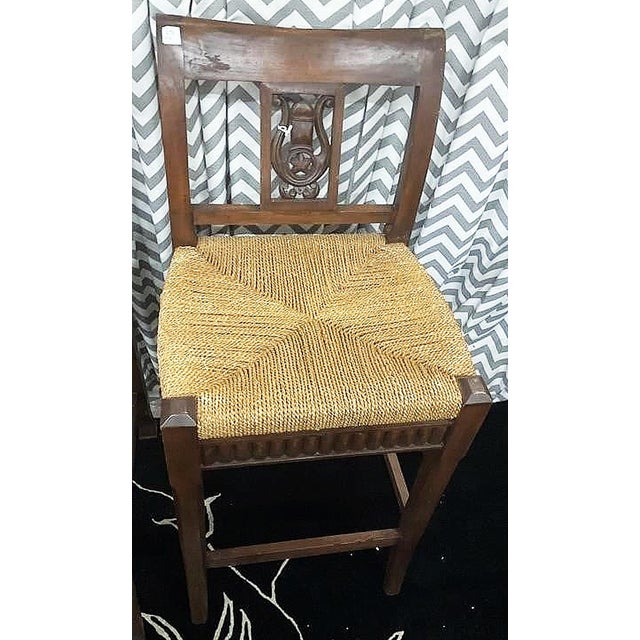 Solid pair of hand carved mahogany bar stools in the provencal style, rushed seating surface and lyre motif back splats....