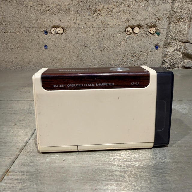 For your consideration, a vintage Panasonic KP-2A battery-operated pencil sharpener, recognized by its signature faux...