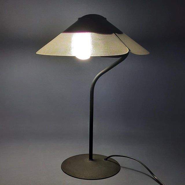Piece of Italian modernism of rare beauty, a table lamp dating back to the 1970s that stands out for its formal elegance...