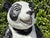 A charming vintage seated panda sculpture crafted in hollow earthenware ceramic with a richly crackled black and white...