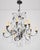 French style chandelier made of faceted teardrop and octagon shaped crystals paired with a black painted steel frame and...