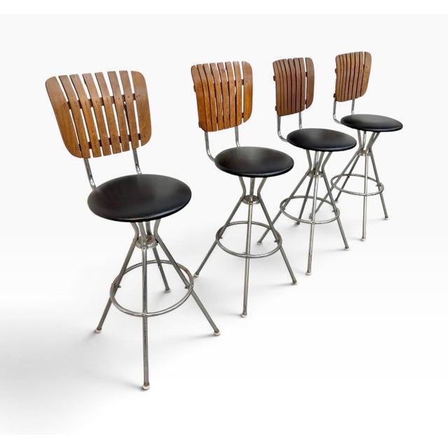 Bring authentic mid-century character to your bar or kitchen with this set of four Umanoff-style slatted bar stools, circa...
