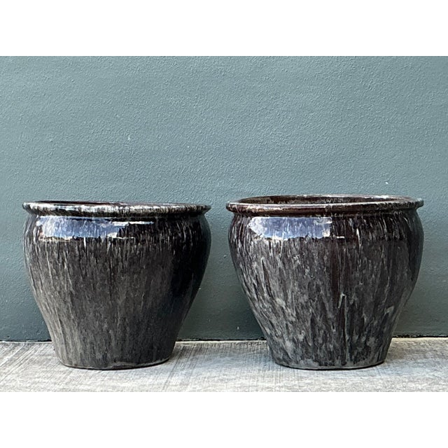 This pair of vintage glazed ceramic planters brings depth, weight, and artisanal character to any planting scheme. Each...