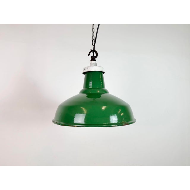 Industrial green enamel factory pendant light made in United Kingdom during the 1960s. White enamel inside the shade. Iron...
