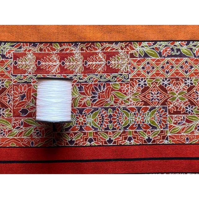 Vintage Red silk with a printed floral bohemian style pattern on the front and stripes on the reverse. 14 in wide x 8.5...