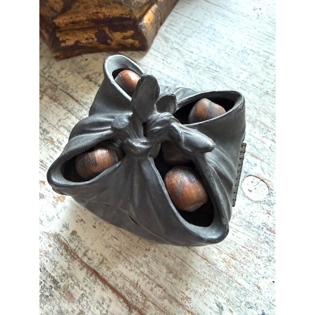 Antique bronze gathered bag form inkwell or box. Features real nuts in the top.