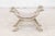 An Italian midcentury Empire style painted bench with carved ram heads and new upholstery. This exquisite Italian painted...