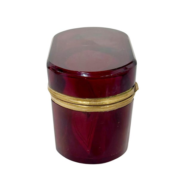 A striking French glass box in a rich ruby red tone, dating to the late 19th century. The vivid coloration is beautifully...