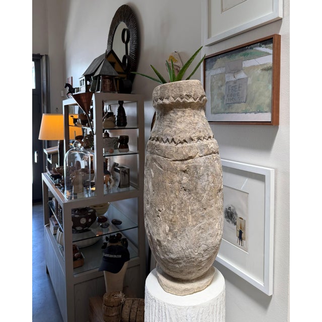 Beautiful Indonesian carved stone vessel measuring 12"DIA x 30"H. There is a 4" deep carved hole in the top which could be...