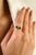 This contemporary bow motif ring features two vivid trillion-cut natural emeralds totaling 0.77 carats, set in 14k white...