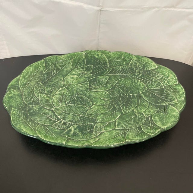 The Vietri Majolica Foglia Leonardo 16" Oval Platter is a stunning piece of ceramic pottery crafted in Italy. Featuring a...