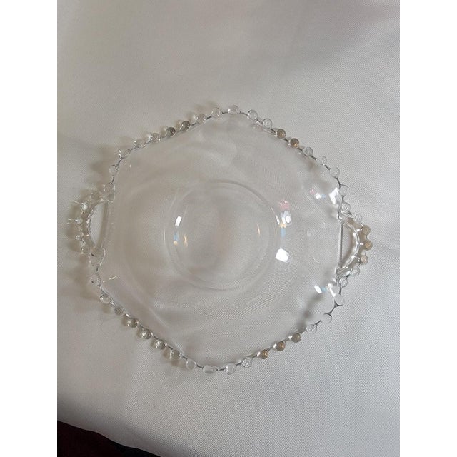 This 8" crimped plate with handle is a beautiful piece of glassware from Imperial Glass-Ohio. Made in America, this clear...