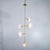 Modern brass chandelier with thin circular opaline glass shades