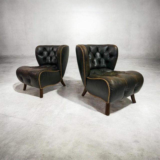 A striking and rare pair of Danish lounge chairs dating from the 1940s, embodying the sculptural elegance and exceptional...