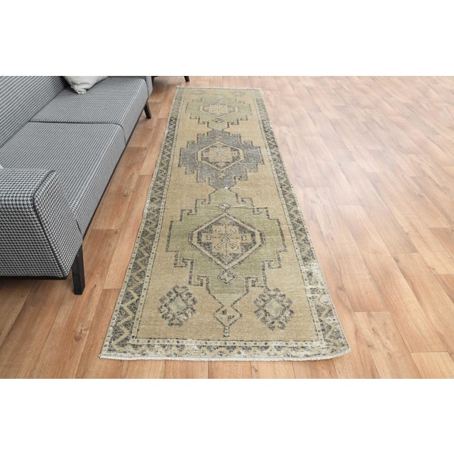 Vintage Hand-Knotted runner rug is a semi-antique vintage area rug. The '70s Eastern region of Anatolia's unique rug is...