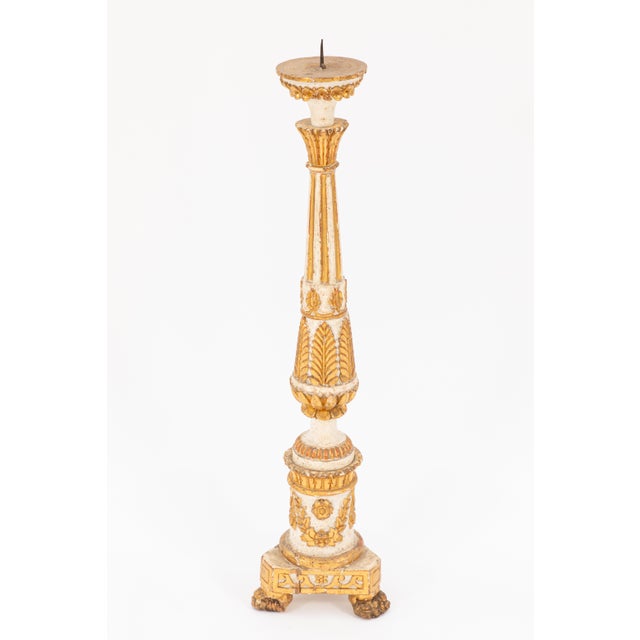 A decorative pair of 18th century Italian painted and parcel-gilt wood pricket candlesticks. Each features a cream-painted...
