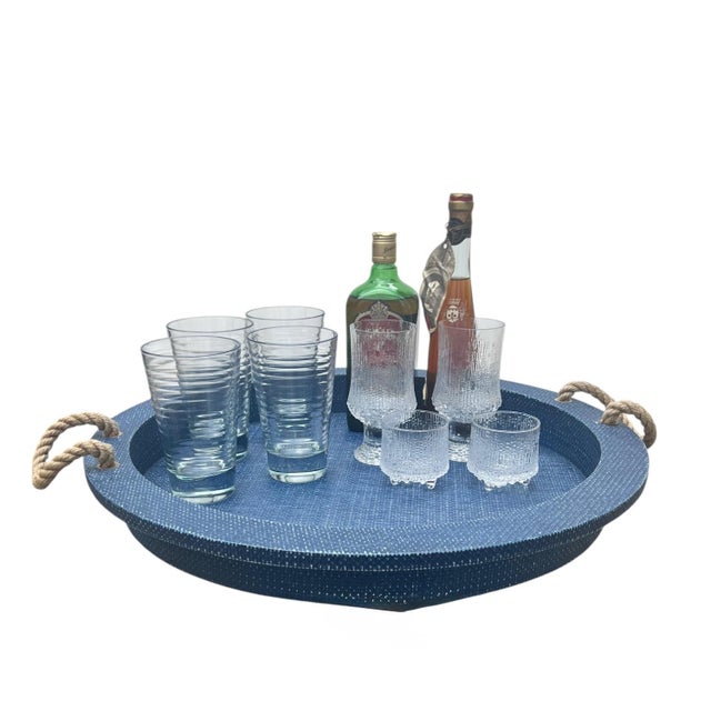 Large scale serving tray in an indigo sealed faux rattan finish with raised edges and jute rope handles and brass...