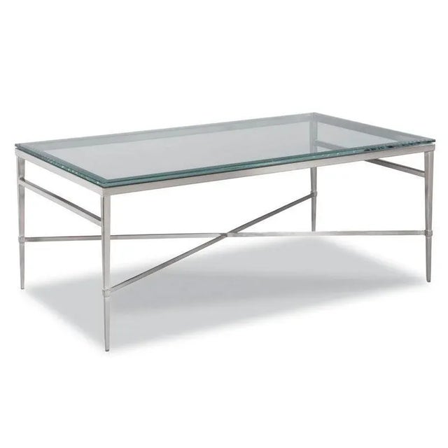A terrific modern form crafted in metal and finished in a polished nickel. A rectangular beveled glass top rests over four...