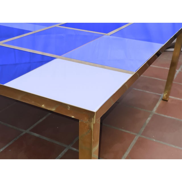 This square coffee table with blue mirrored Murano glass and brass trim is a stunning piece of modern design, handcrafted...