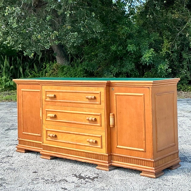 Add a splash of coastal sophistication to your space with this vintage rattan-trimmed credenza. Featuring clean lines and...