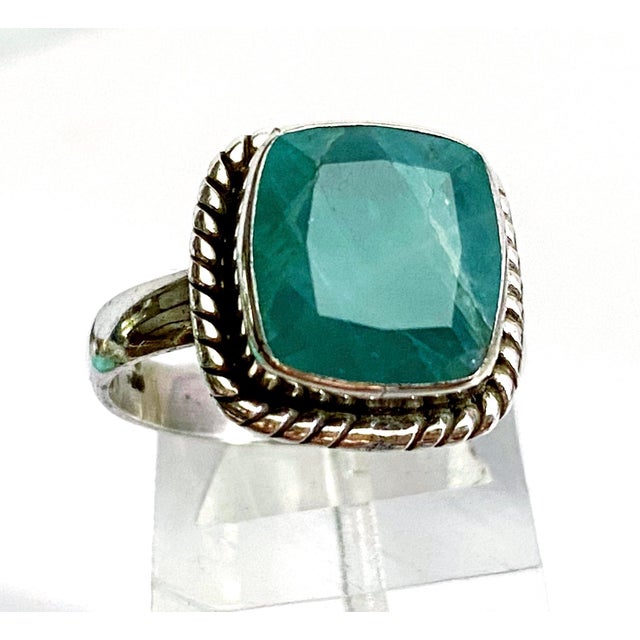 A striking solitaire ring showcasing an exceptionally rare grandidierite gemstone, prized among collectors for its...
