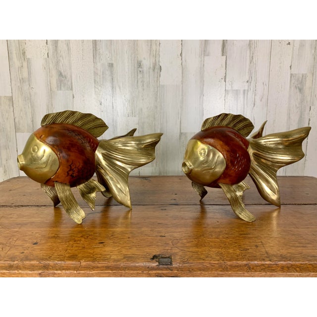 Vintage decorative koi fish sculptures. Hand shaped and carved wood with brass accents.